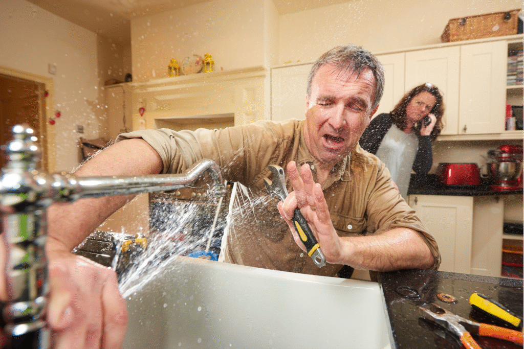 Plumber helping a customer repair a leaky faucet